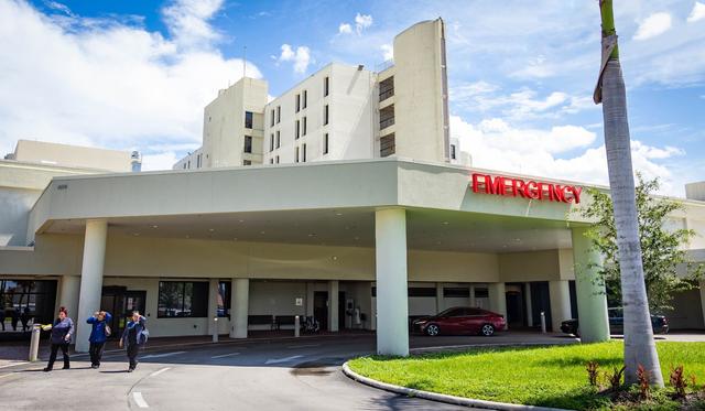 Three employees leave Palmetto General Hospital through the emergency entrance on Friday, Sept. 20, 2024, in Hialeah, Fla.